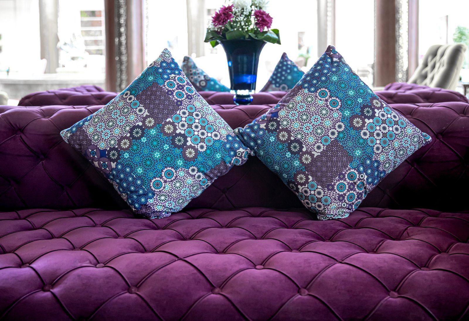 purple-velvet-fabric-modern-sofa-with-sunken-buttons-colorful-decorative-pillows-idea-variant-fabric-upholstery-sofa-scaled.jpg